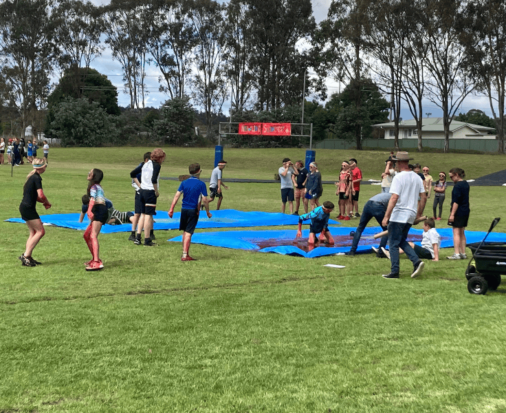 A group of students participating in Slimefest. They are diving around in messy slime.