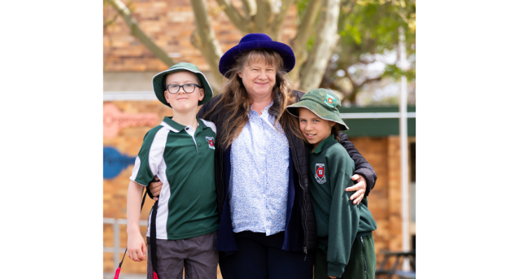 A staff member with two students showing how much she cares about them.