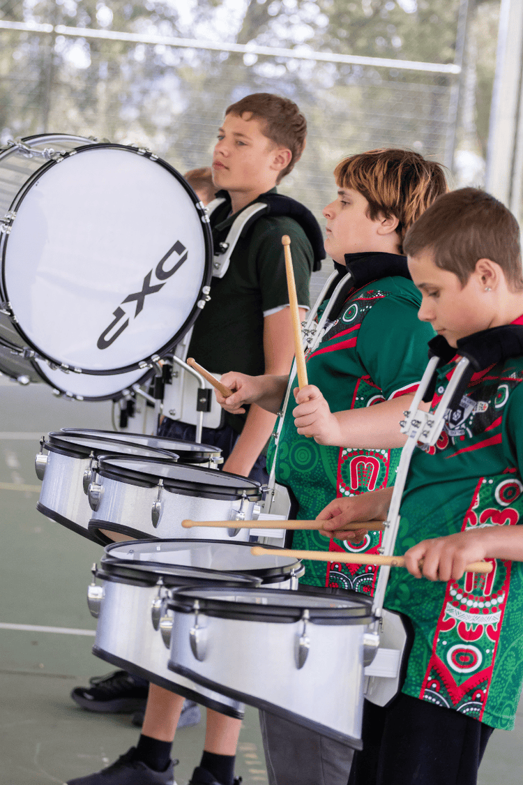 Year 6 students palying the drums.